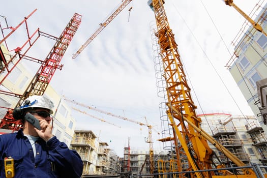 construction worker, engineer, with large building site in background, wide-angle perspective