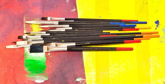 Paintbrushes on colorful background