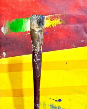 Paintbrushes on colorful background