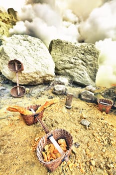 Baskets with sulfur in Ijen crater. Java. Indonesia