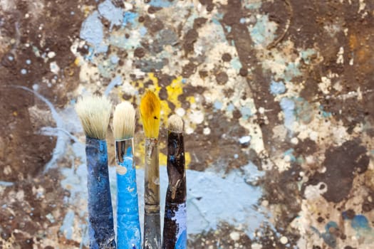 Paintbrushes on colorful background