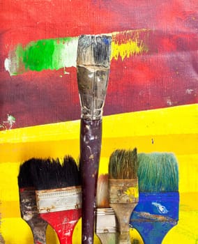 Paintbrushes on colorful background