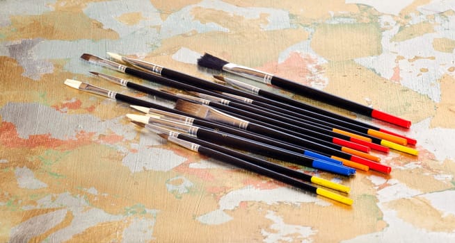 Paintbrushes on colorful background