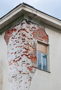 Decayed Ukraine house. Crack of brick wall