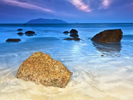 Sunrise over the sea. Stone on the foreground
