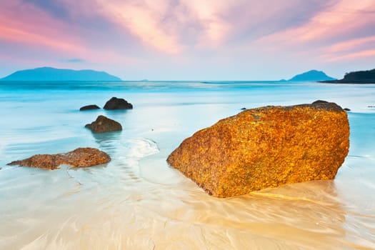 Sunrise over the sea. Stone on the foreground