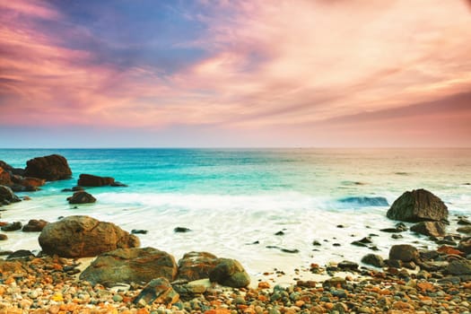 Sunrise over the sea. Stone on the foreground