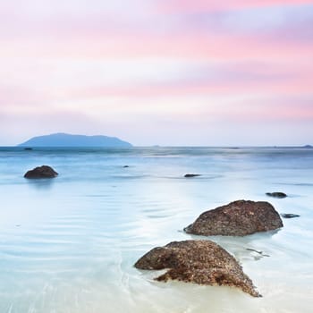 Sunrise over the sea. Stone on the foreground