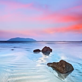 Sunrise over the sea. Stone on the foreground