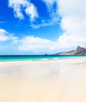 Beautiful white sand beach. Island on background