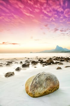 Sunrise over the sea. Stone on the foreground