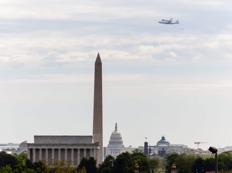 WASHINGTON DC - APRIL 17: Space Shuttle Discovery flies over Washington DC on April 17, 2012 on route to its final resting place in the Air and Space Museum