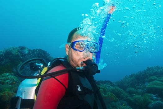 Scuba diver underwater making bubbles
