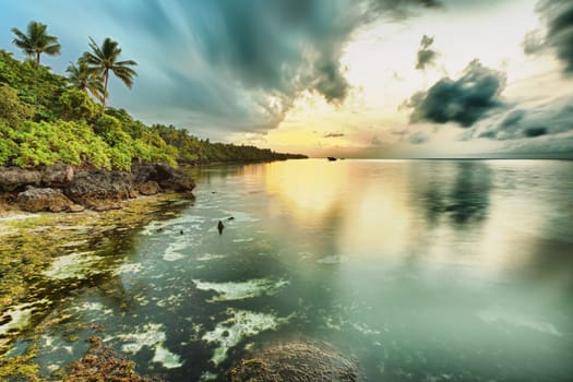 Sunrise over the sea. Stone on the foreground