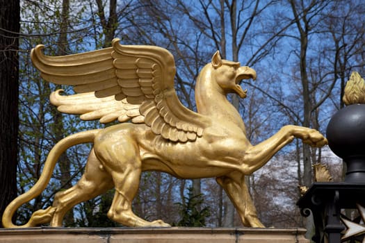 Golden mythical creature in Berlin at the entrance to the palace garden in Glienicke