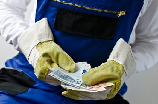 Craftsman holds money in his hands