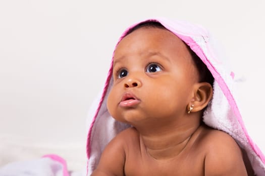 Adorable little african american baby girl  looking up