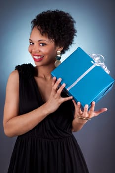 Young African American woman holding a gift box