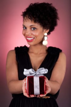 Portrait of a young African American woman offering a gift