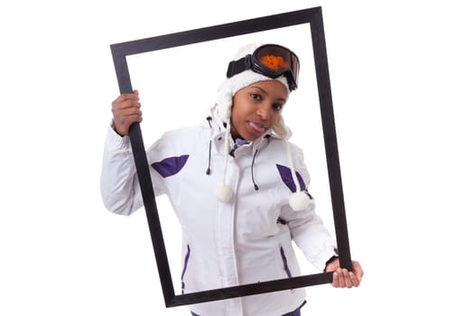 Young african woman in ski clothes  holding a picture frame, isolated on white background