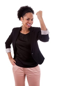 African american woman celebrating success with clenched fists on white background