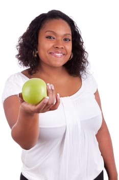 Young african american woman giving an  green apple, isolated on white background