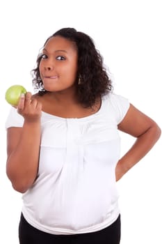 Young african american woman eating an  green apple, isolated on white background