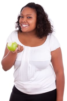 Young african american woman eating an  green apple, isolated on white background