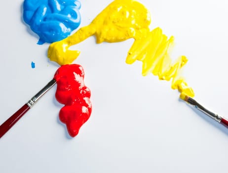 Paintbrushes with Blue, yellow and red Colors on white background