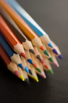 A lot of Colorful pencils on a black background