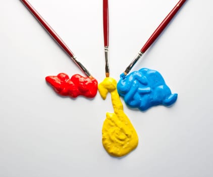 Paintbrushes with Blue, yellow and red Colors on white background