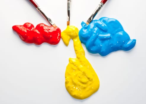 Paintbrushes with Blue, yellow and red Colors on white background