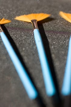 Fan shaped paintbrushees on anthracite background