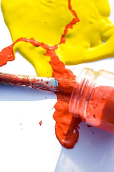 Photo of Yellow and red colors and paintbrush