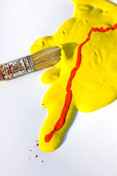 Photo of Yellow and red colors and paintbrush