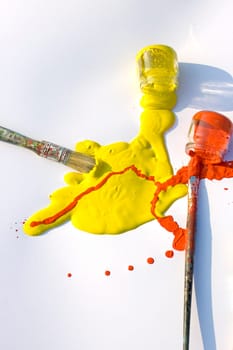 Photo of Yellow and red colors and paintbrush