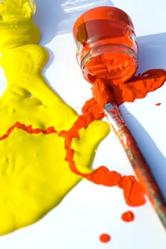 Photo of Yellow and red colors and paintbrush