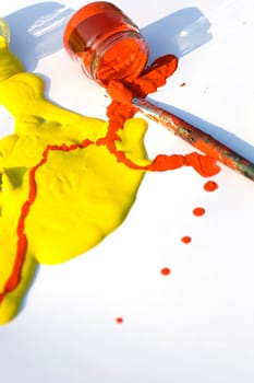 Photo of Yellow and red colors and paintbrush