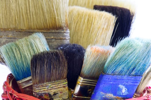Paintbrushes inside a wicker basket