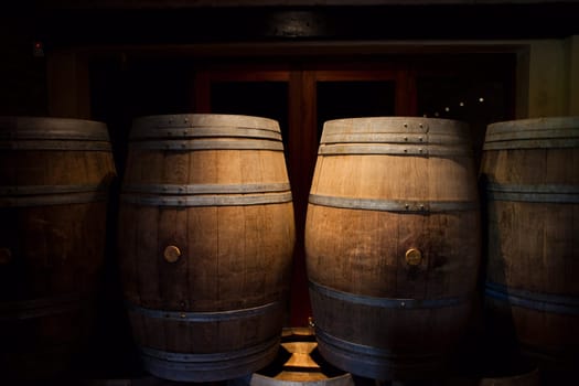 Barrels of South African wine in a wine cellar