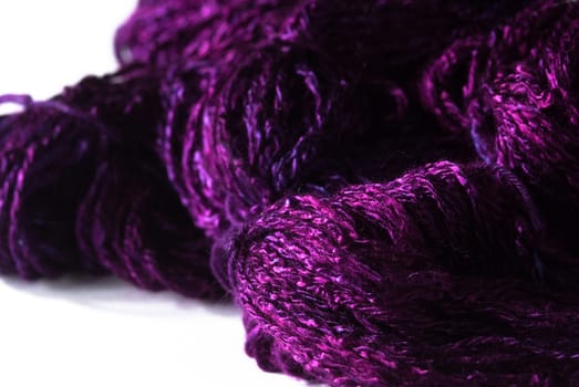 Handmade bundle of purple yarn on white