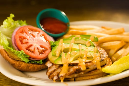Avocado chicken burger with fries