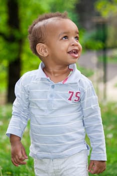 Portrait of a african american  baby boy playing  at the park