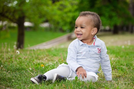 Portrait of a african american  baby boy playing  in the park