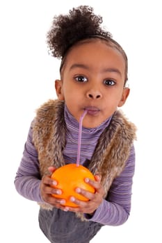 Little black girl drinking orange juice with a straw