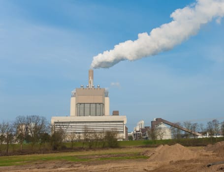 power plant with smoking chimney in Nijmegen, Netherlands