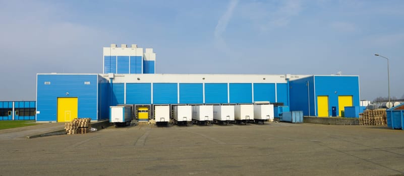 modern blue warehouse with loading docks
