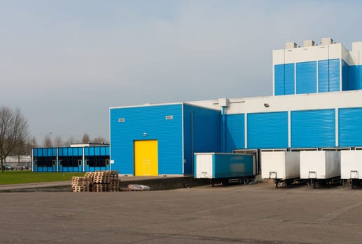 modern blue warehouse with loading docks