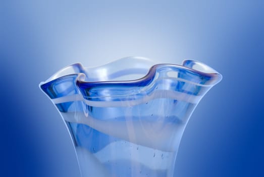 Closeup of a neck of a blue vase with curves (on white)
