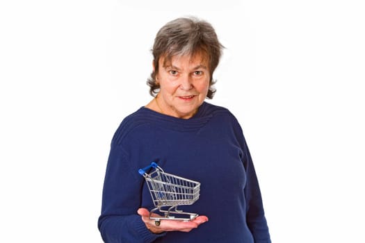 Senior woman with model shopping cart - isolated on white background